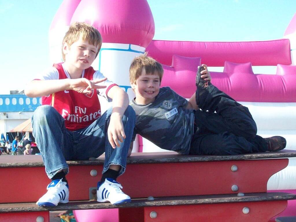 A young Alfie Crooks wearing his Arsenal shirt with pride