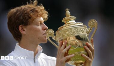 Jannik Sinner kisses the Wimbledon trophy