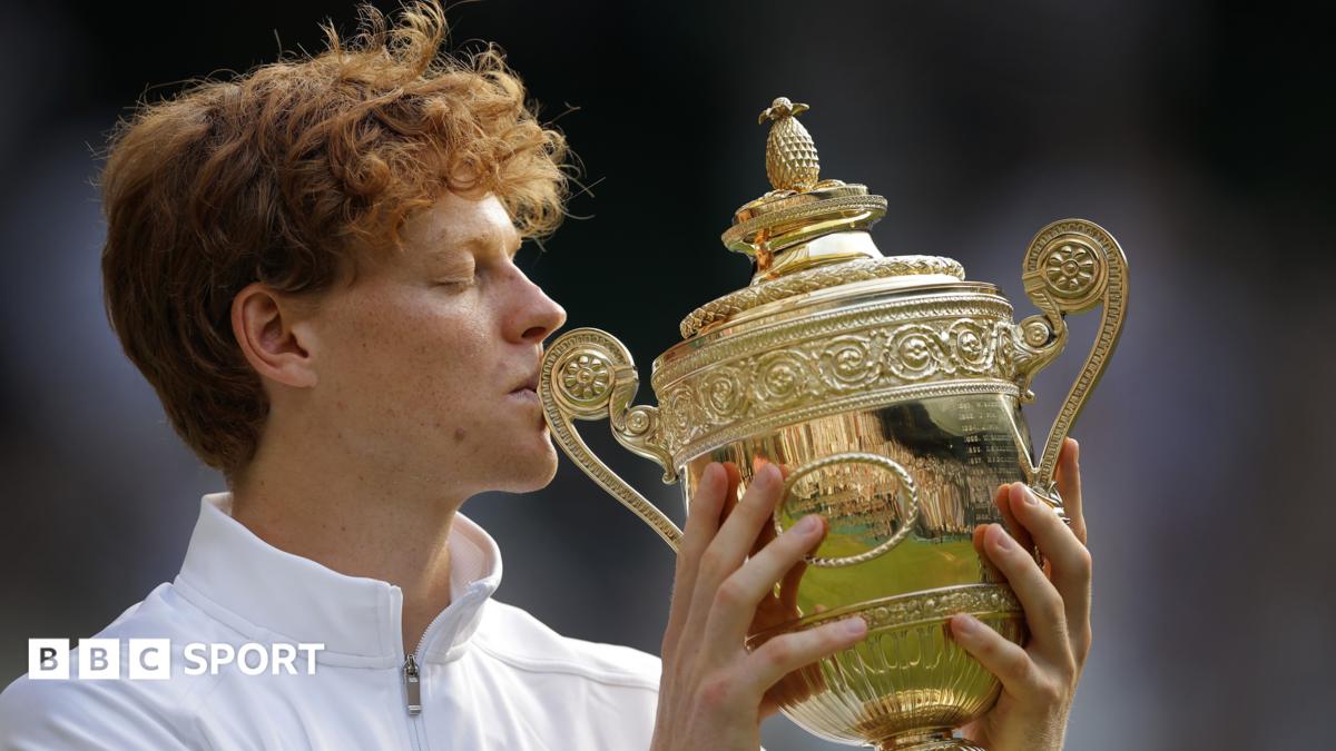 Jannik Sinner kisses the Wimbledon trophy