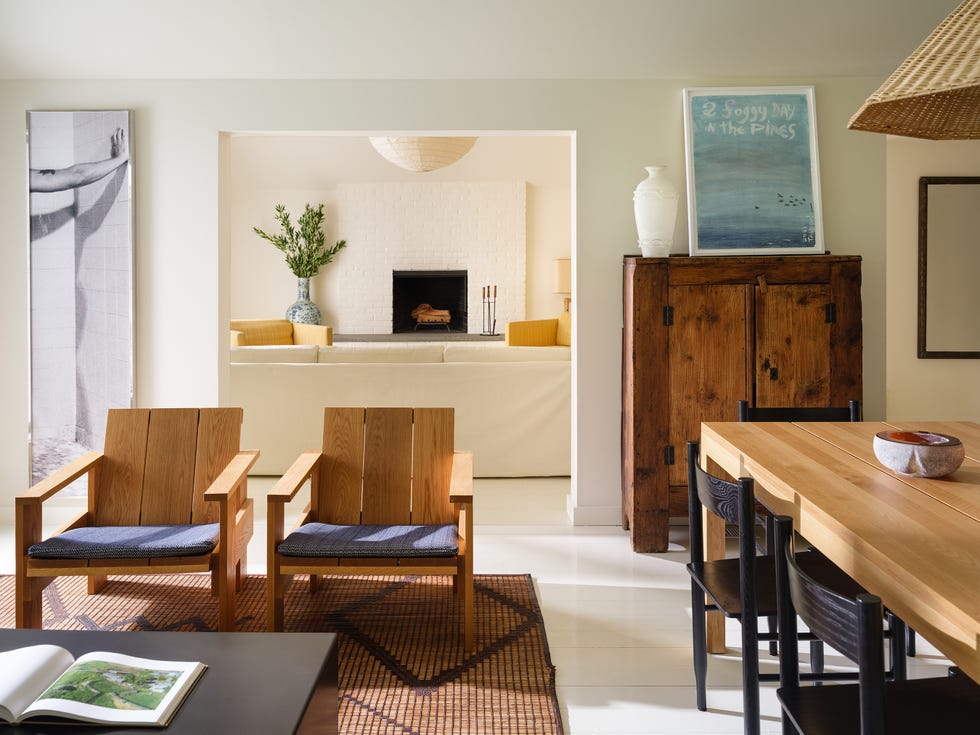 Contemporary living room with wooden furniture, art, and a fireplace.
