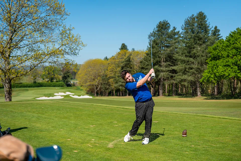 Matt Cradock hitting a 7-iron off the tee at Tandridge Golf Club