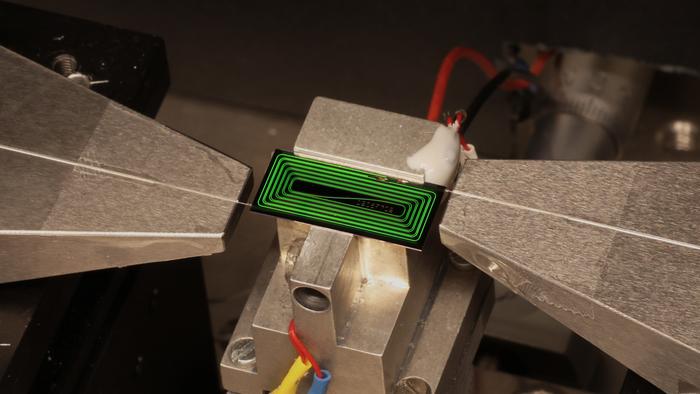 A close up of a chip on a metal platform.