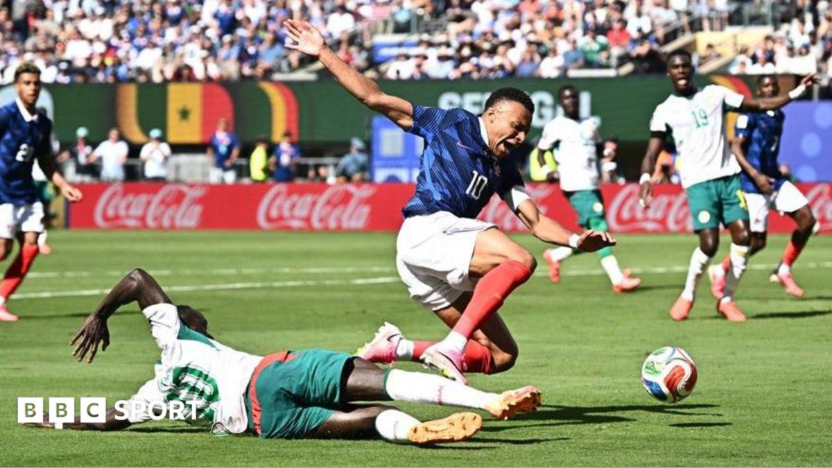 Senegal's Sadio Mane challenges France's Kylian Mbappe in the penalty area leading to a VAR review