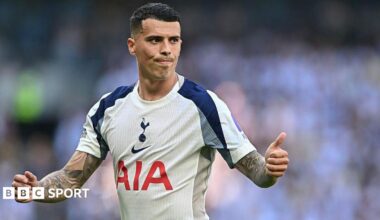 Pedro Porro, wearing a white Tottenham shirt, gives a thumbs up