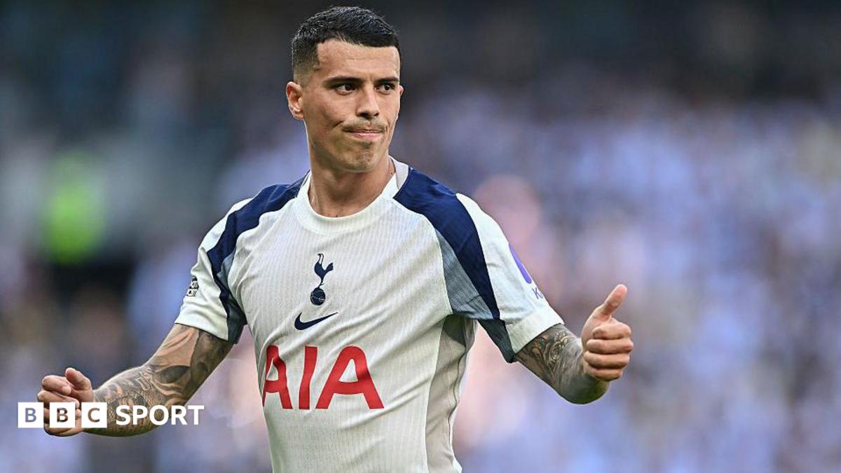 Pedro Porro, wearing a white Tottenham shirt, gives a thumbs up