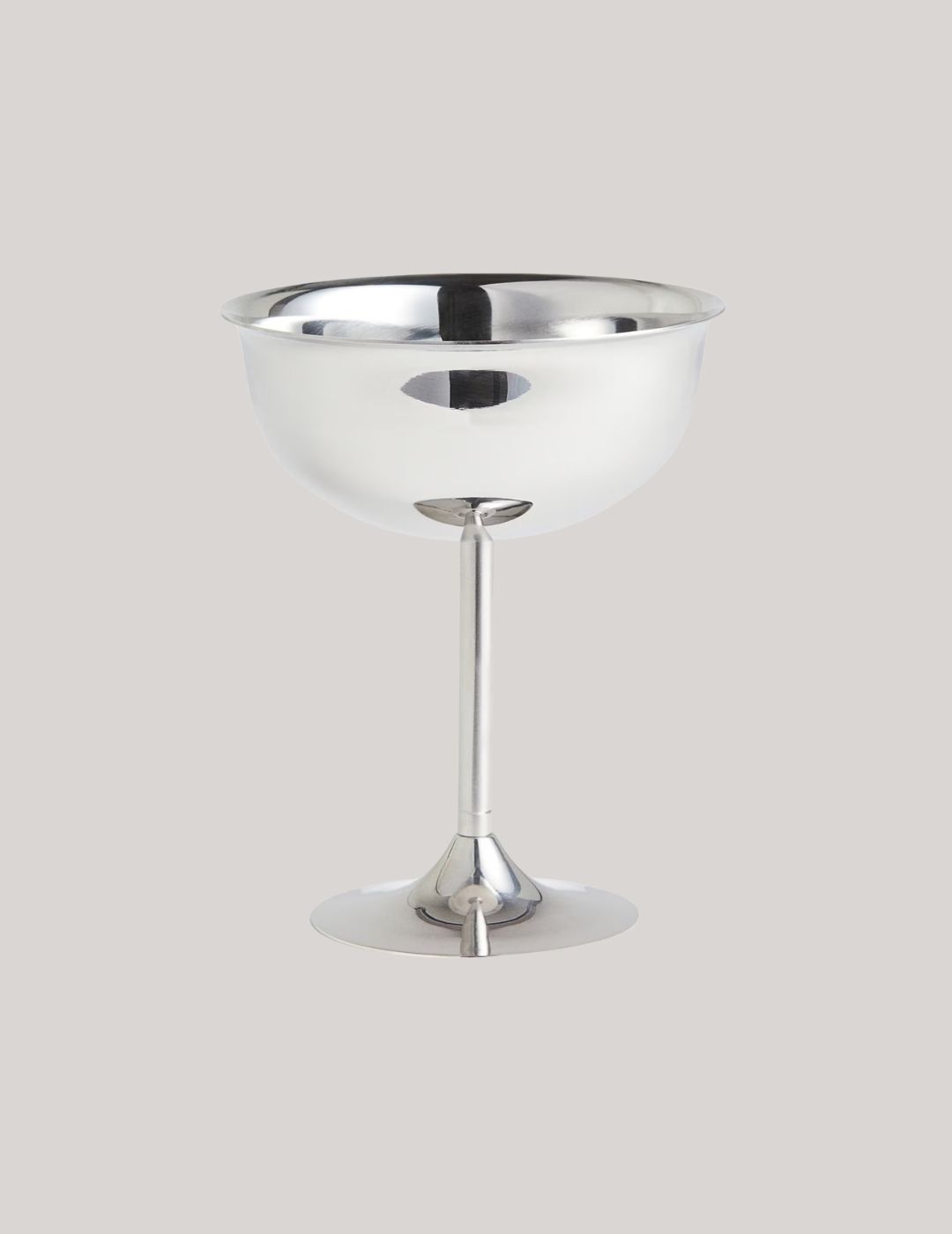 Tall Stainless Steel Coupe against pale brown backrground.