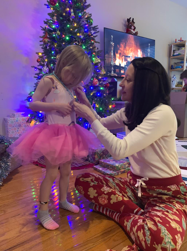 The author wearing her wig on Christmas morning, celebrating with her daughter.