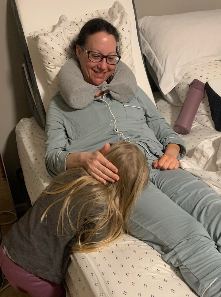 The author recovering from her double mastectomy, and her daughter giving her a gentle hug.