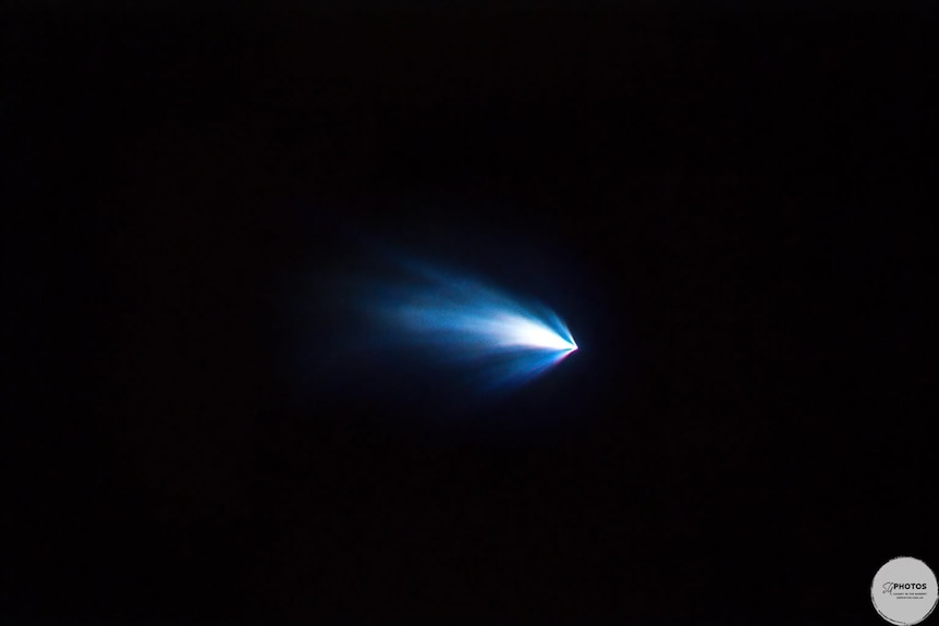 A bright light streaking across sky