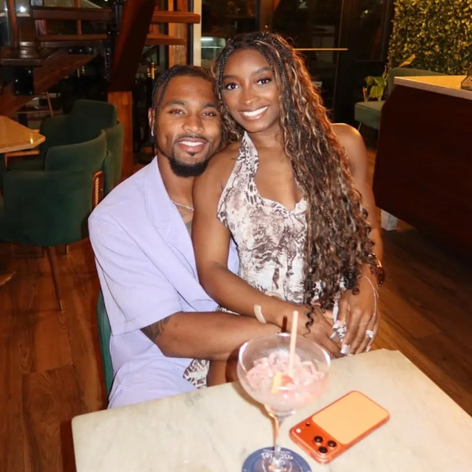 Simone Biles and her husband Jonathan Owens pose for a photo on vacation in Belize