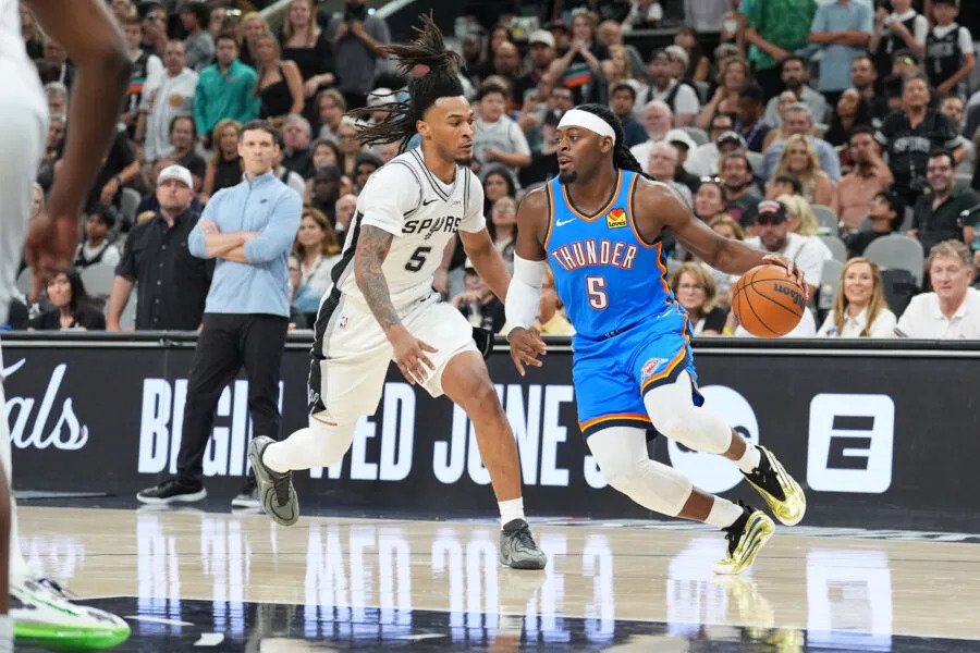 May 24, 2026; San Antonio, Texas, USA; Oklahoma City Thunder forward Luguentz Dort (5) moves the ball while defended by San Antonio Spurs guard Stephon Castle (5) in the fourth quarter during game four of the western conference finals for the 2026 NBA playoffs at Frost Bank Center. Mandatory Credit: Daniel Dunn-Imagn Images