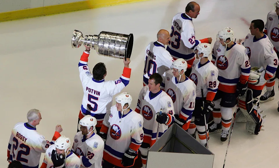 UNIONDALE, NY - MARCH 02: Former New York Islanders legend Denis Potvin carries the Stanley Cup before the game against the Florida Panthers at the Nassau Coliseum March 2, 2008 in Uniondale, New York. The Islanders are celebrating the 17 men that were part of all four Stanley Cup winning teams from 1980-1983. (Photo by Jim McIsaac/Getty Images)