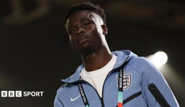 Bukayo Saka in a pale blue England tracksuit
