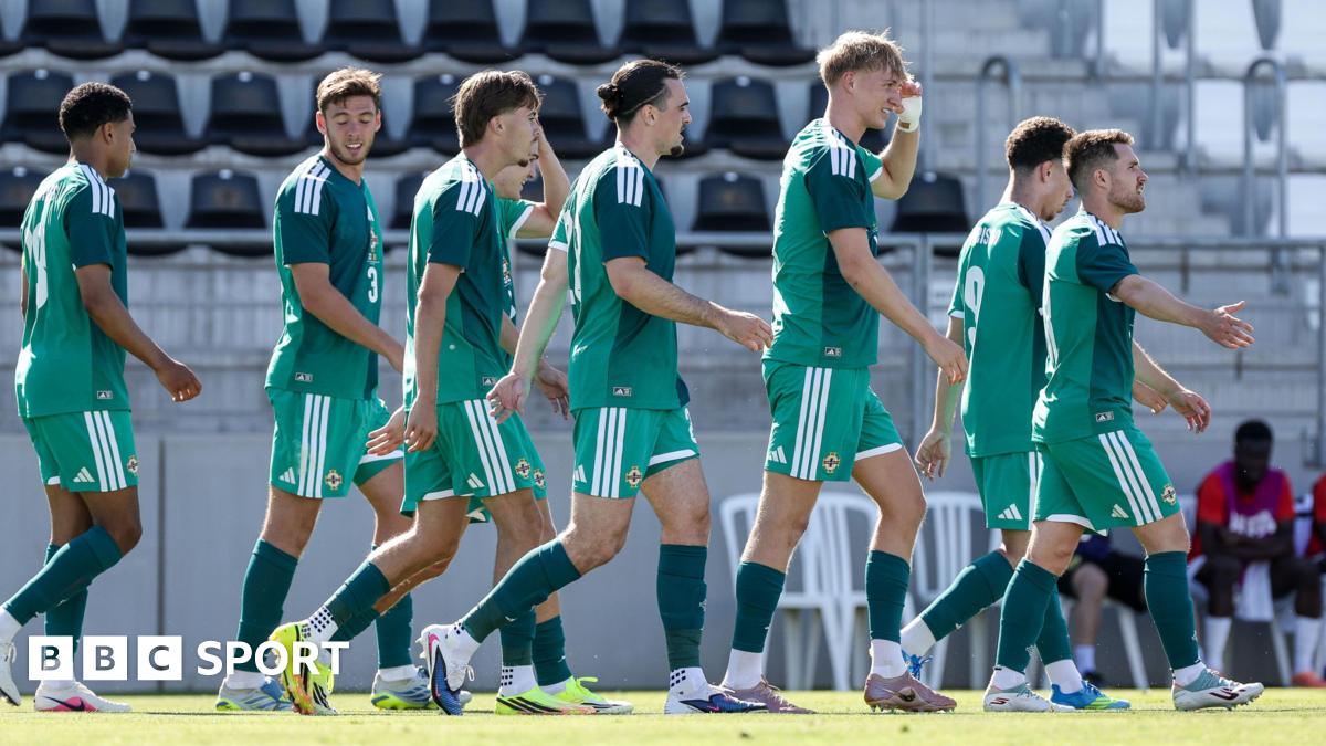 Northern Ireland players walk back to the halfway line while celebrating