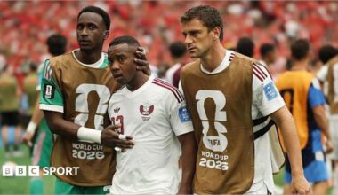 Qatar's Assim Madibo is comforted by team-mates after getting sent off in their World Cup game against Canada in 2026