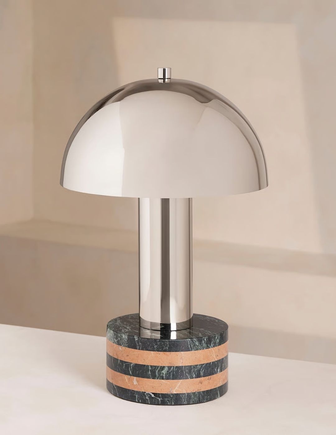 Bowen Table Lamp with marble base and mushroom-shaped chrome body, set atop a white surface.