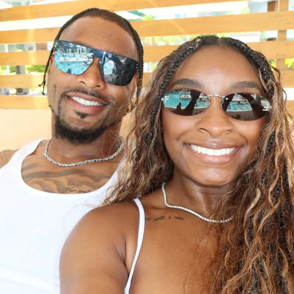 Simone Biles and her husband Jonathan Owens pose for a photo on vacation in Belize