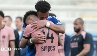 Guela Doue of Strasbourg (blue jersey) hugs his brother Desire Doue of Paris St-Germain following a match in May 2025