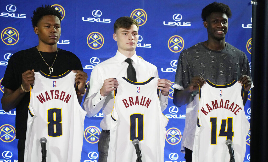 Denver Nuggets selections from the NBA draft, from left to right, Peyton Watson, Christian Braun and Ismael Kamagate hold up their jerseys as they are introduced to the media during a news conference Monday, June 27, 2022, in Denver. (AP Photo/David Zalubowski)
