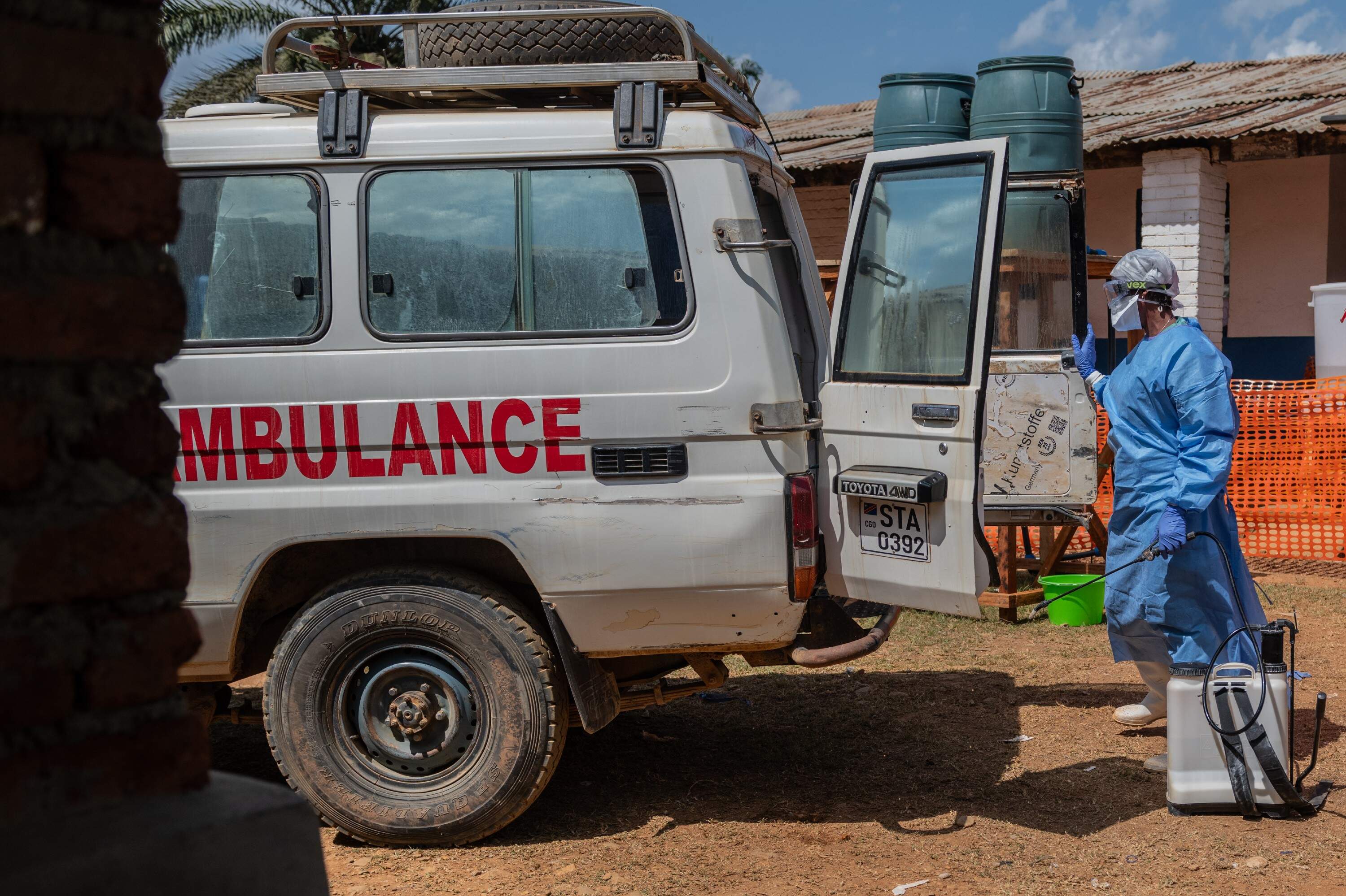 A health worker disinfects an ambulance at a treatment center that transported a suspected Ebola patient in Mongbwalu, a small town in the Djugu Territory of the Ituri Province in the Democratic Republic of the Congo (DRC) on June 5. (Moses Sawasawa/ AP)