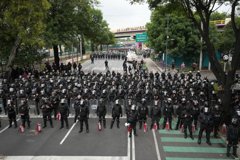 Police block an avenue to prevent protesting teachers from marching to the stadium that will host the opening match of the FIFA World Cup 