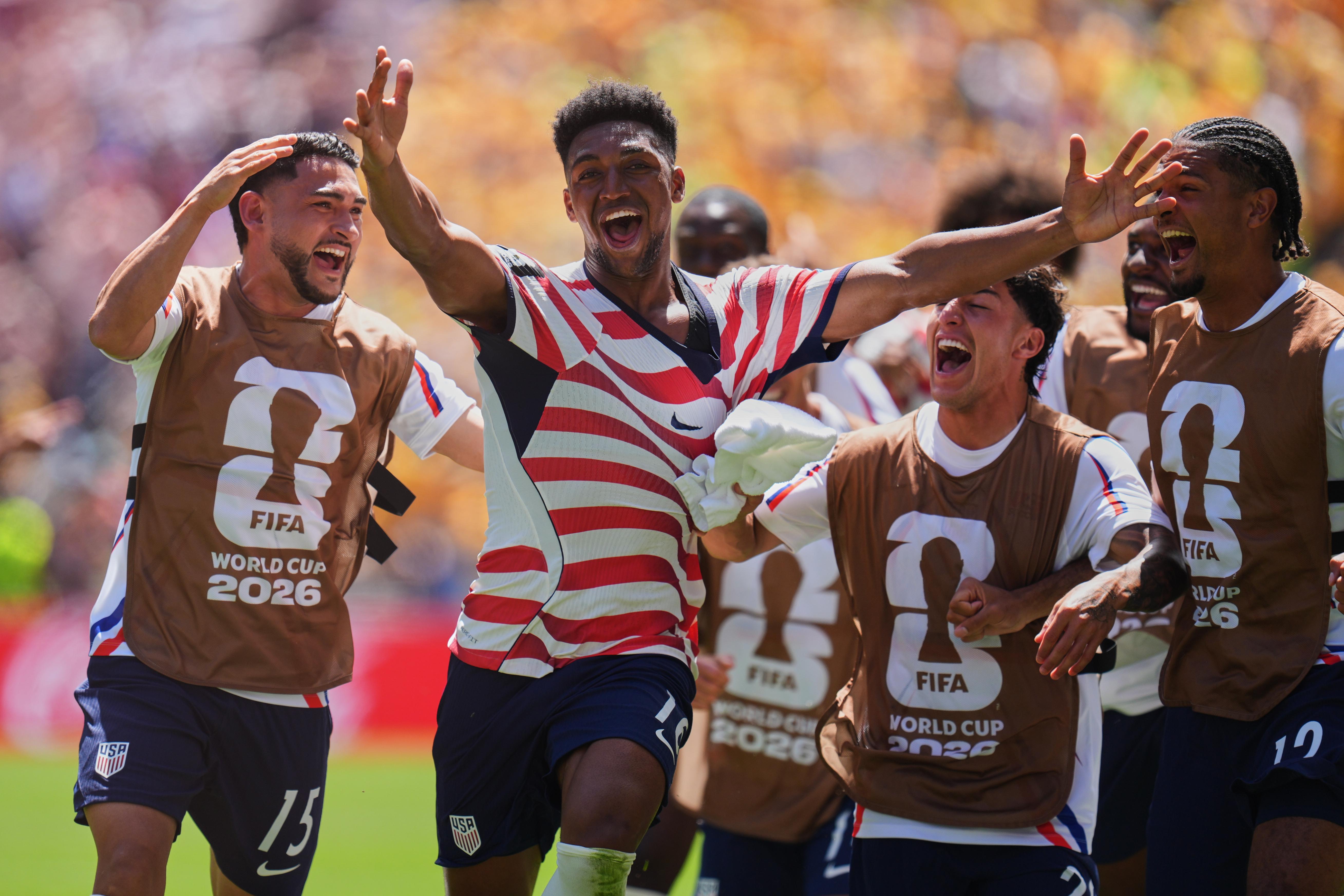 United States’ Alex Freeman (16), second left, celebrates after scoring...