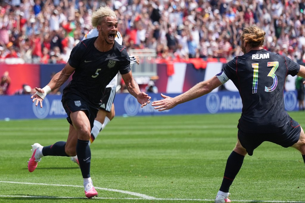 United States defenders Antonee Robinson, left, and Tim Ream celebrate after Robinson scored a goal during the first half of an international friendly soccer match against Germany in Chicago, Saturday, June 6, 2026. 
