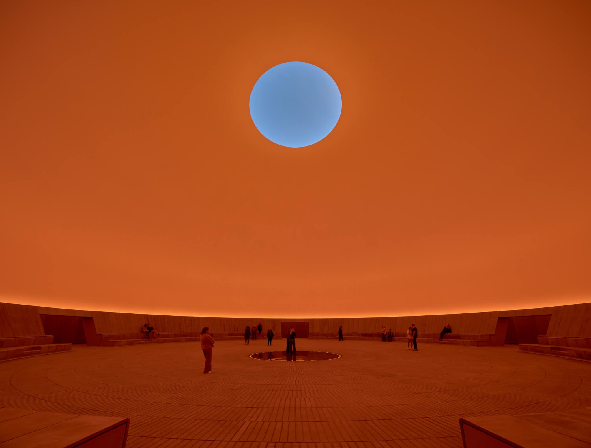 interior of the skyspace at ARoS Aarhus Art Museum lit up orange