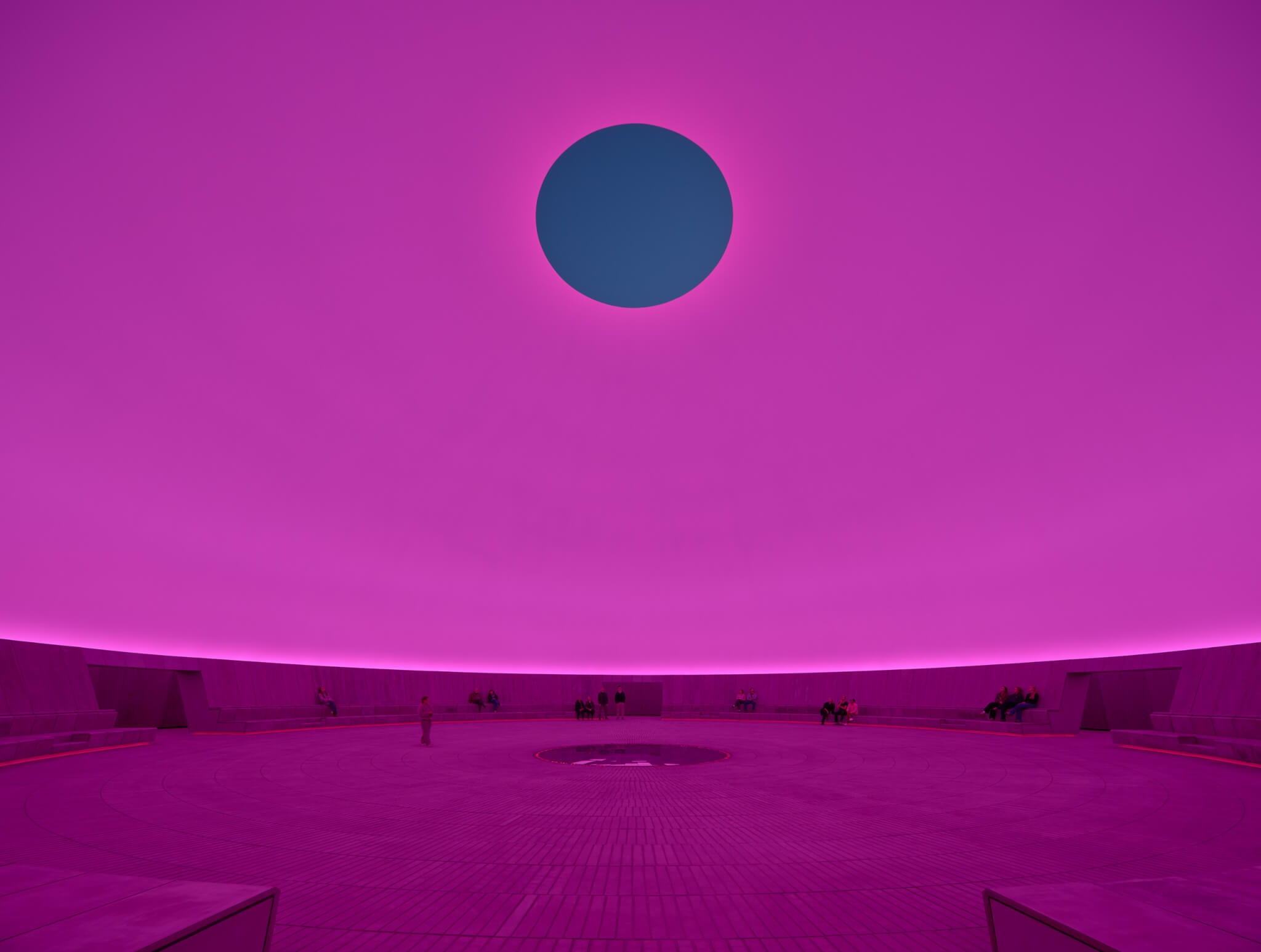 interior of the skyspace at ARoS Aarhus Art Museum lit up pink