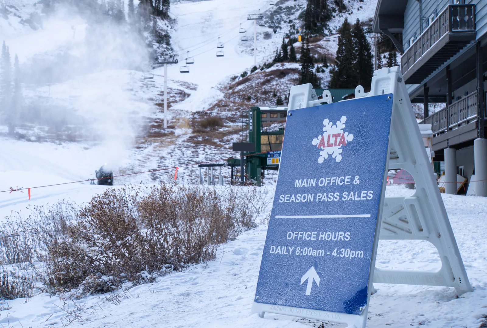 Alta Ski Area ticket sales sign and slopes