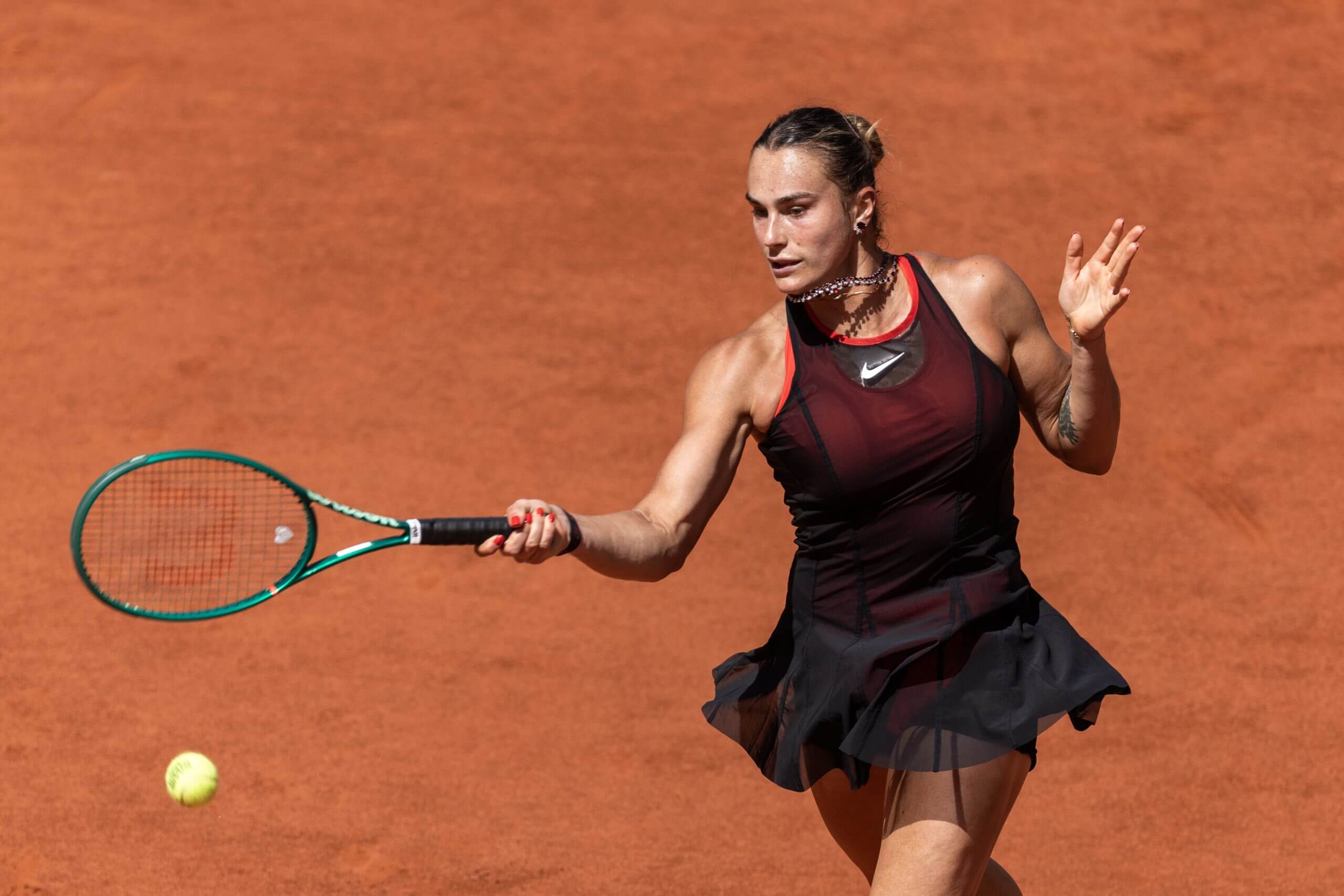 Aryna Sabalenka hits a forehand on a clay tennis court
