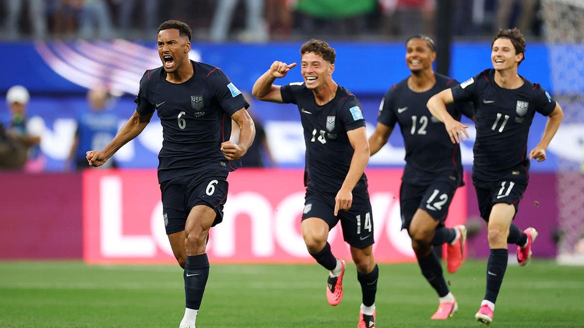 Auston Trusty celebrating with teammates after scoring a goal at Los Angeles Stadium.
