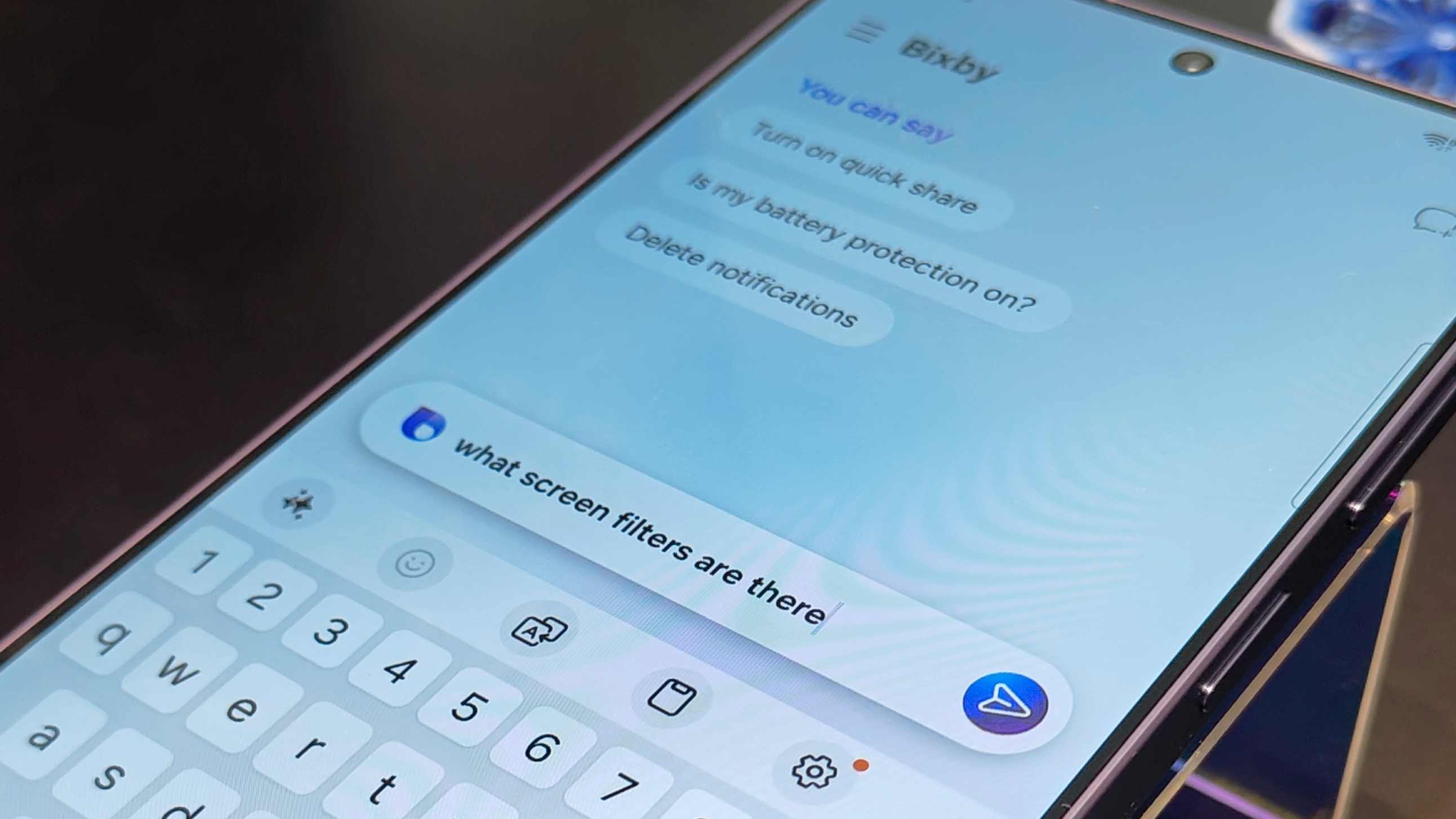 The Samsung Galaxy S26 Ultra with the user asking Bixby a question.