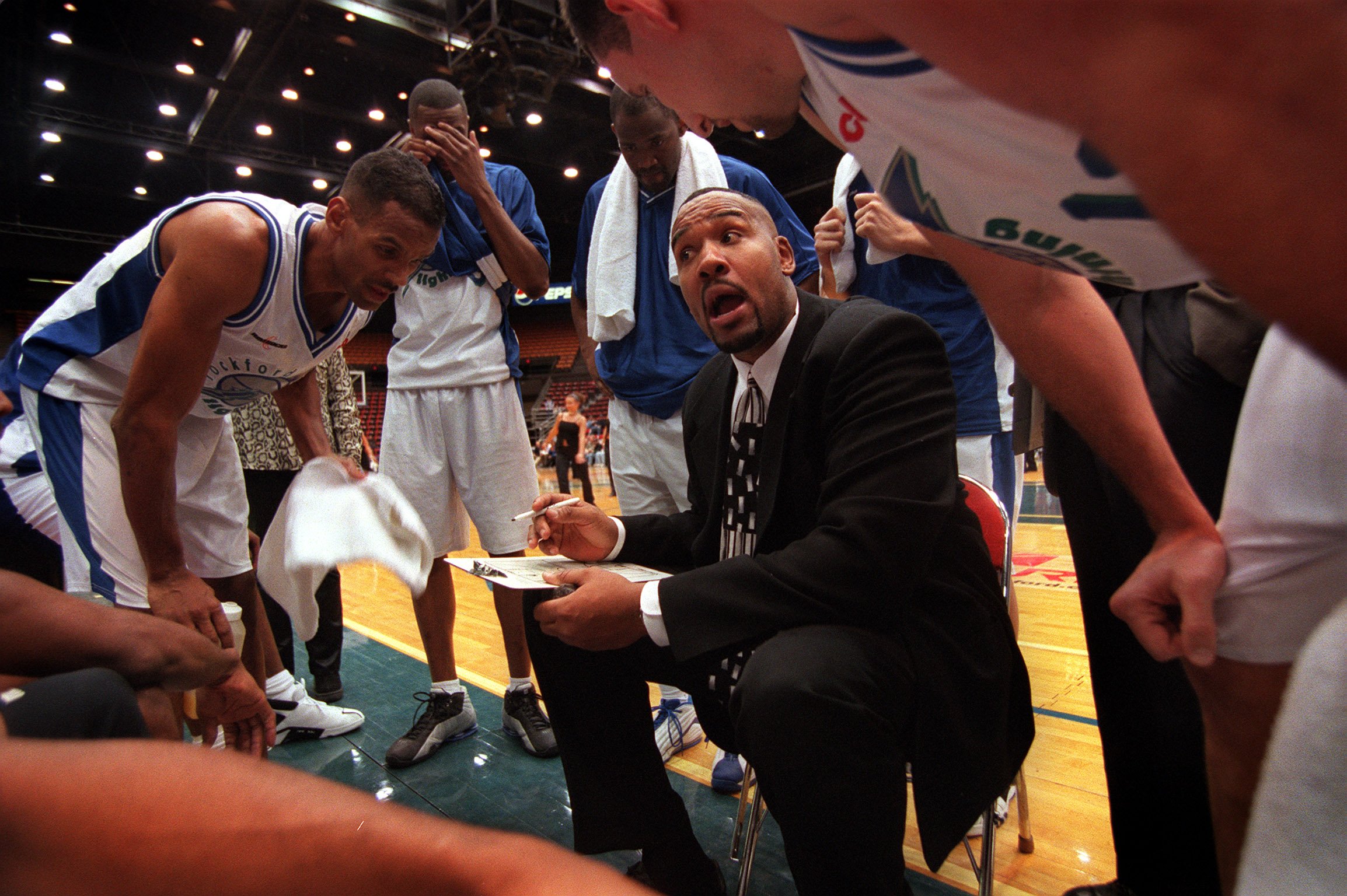 Rockford Lightning head coach Stacey King huddles with players during...