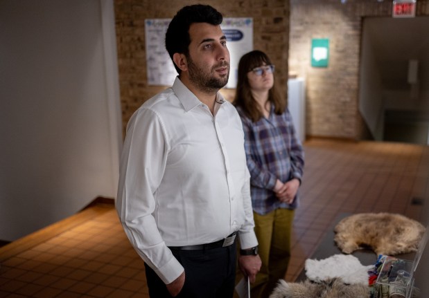 Abdulhaq Sodais, left, and Sarah Vacek, 26, a volunteer with the Riverside Area Refugee Resettlement Team, look at museum artifacts at the Gichigamiin Indigenous Nations Museum in Evanston onMay 8, 2026. Sodais is an Afghan refugee who immigrated to the United States in December of 2025. (Josh Boland/Chicago Tribune)
