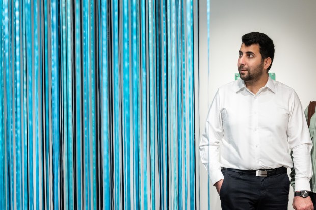 Abdulhaq Sodais, left, looks at the Nibi Water art piece at the Gichigamiin Indigenous Nations Museum in Evanston, May 8, 2026. Sodais is an Afghan refugee who immigrated to the United States in December of 2025. (Josh Boland/Chicago Tribune)