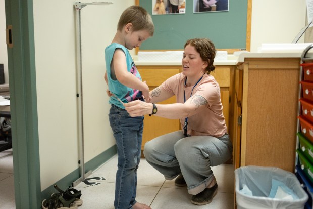 Research coordinator Roxanne Sawhill measures the waist of Jamie Headley, 6, of Urbana, during an Illinois Kids Development Study (IKIDS) microplastics test at the Beckman Institute for Advanced Science and Technology at the University of Illinois Urbana-Champaign on June 18, 2026. Scientists  at the Beckman Institute have been tracking levels of plastic-softening phthalates in the blood of children since before they were born up until age 11. (Josh Boland/Chicago Tribune)