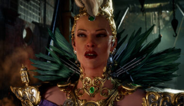 Lady Ironwood, adorned with ornate gold jewelry and green feathers, stands half-lit in shadow, staring menacingly as she speaks.