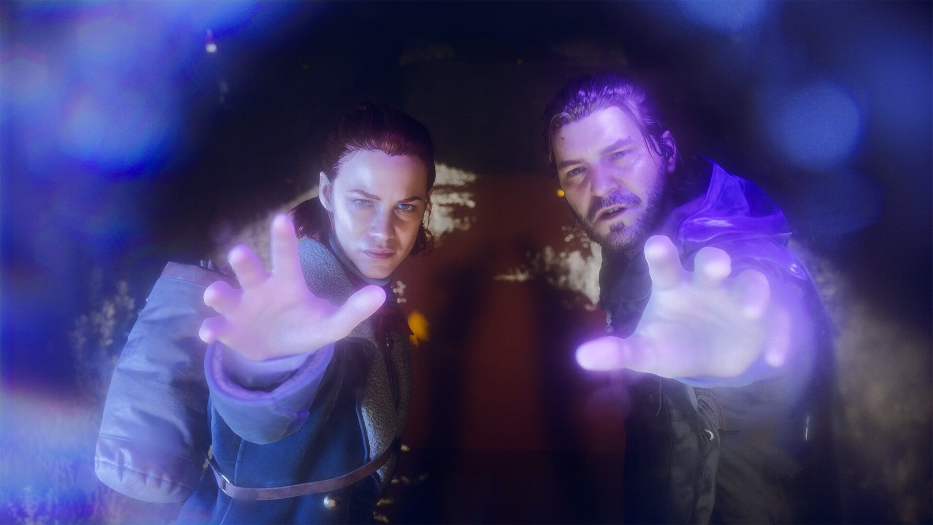 A brother and sister hold up their hands surrounded by purple light.
