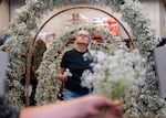 Volunteer Rebecca Geisen mounts flowers onto a float ahead of the Portland Rose Festival in Portland, Ore. June 4, 2026.