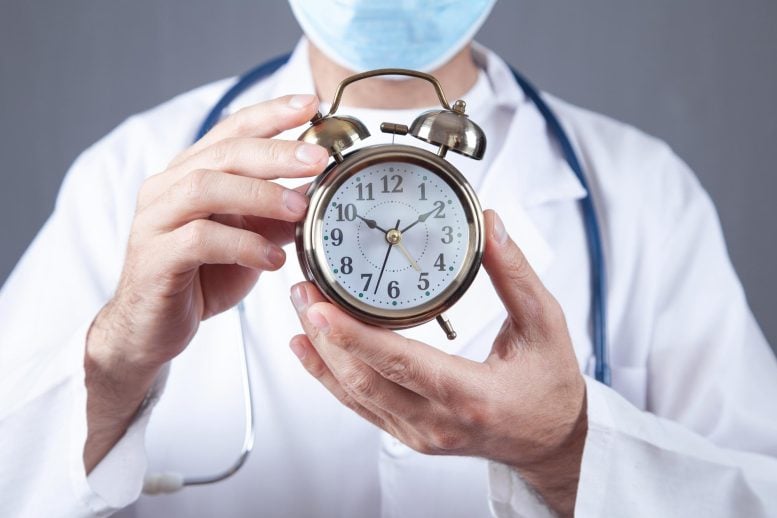 Doctor Holding Alarm Clock Longevity Aging