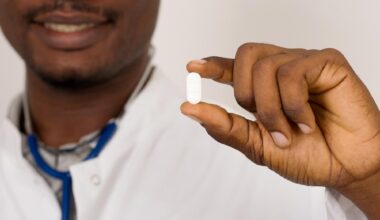 Doctor With Stethoscope Holding White Pill Medicine