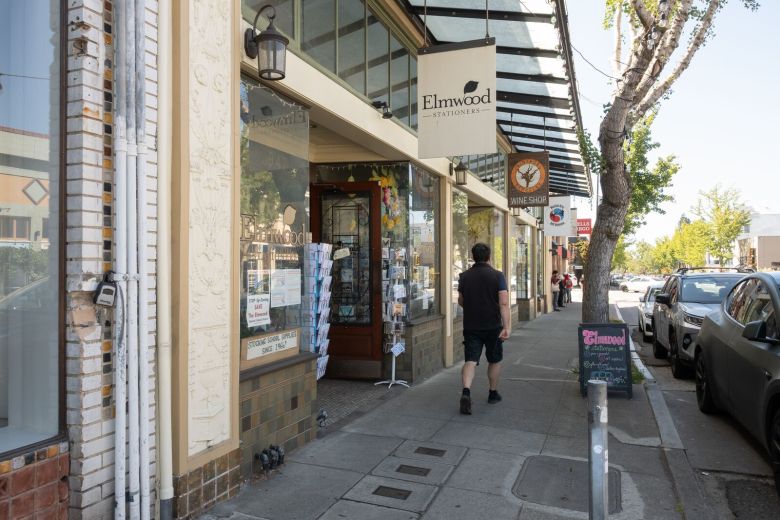A person walks past stores on College Avenue in Berkeley's Elmwood district