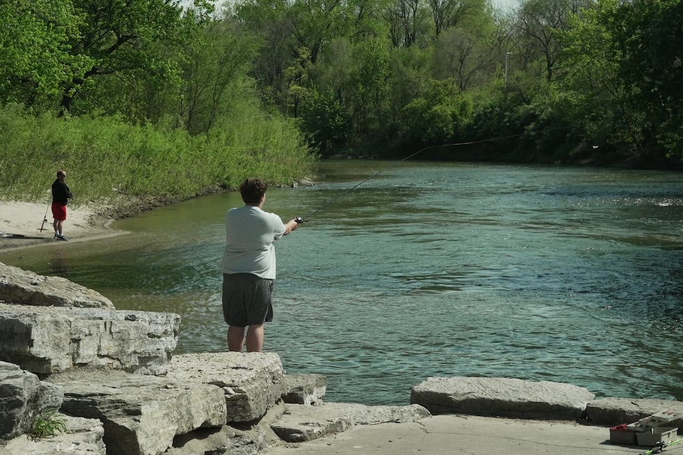 People fish along the Maquoketa River, Thursday, May 7, 2026, in Manchester, Iowa. (AP...