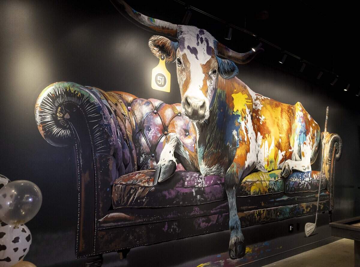 A large mural decorates the inside of Five Iron Golf, which features artwork by local artists.