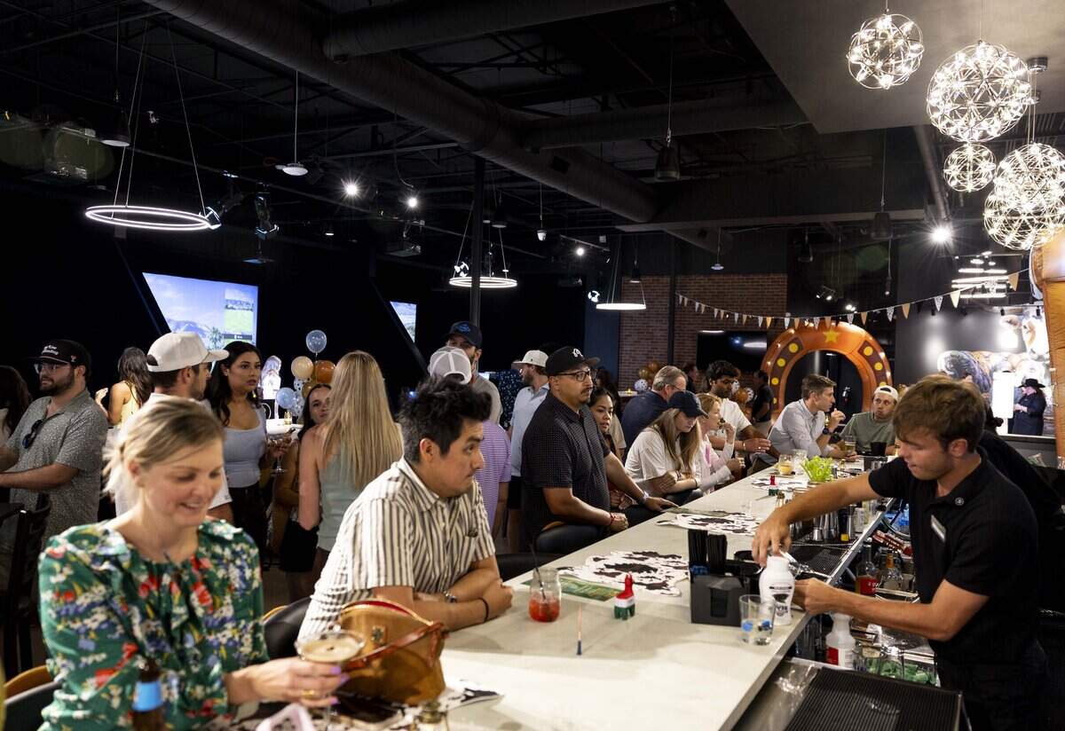 People order drinks during Five Iron Golf's grand opening celebration on Thursday, June 11, 2026 in Fort Worth.