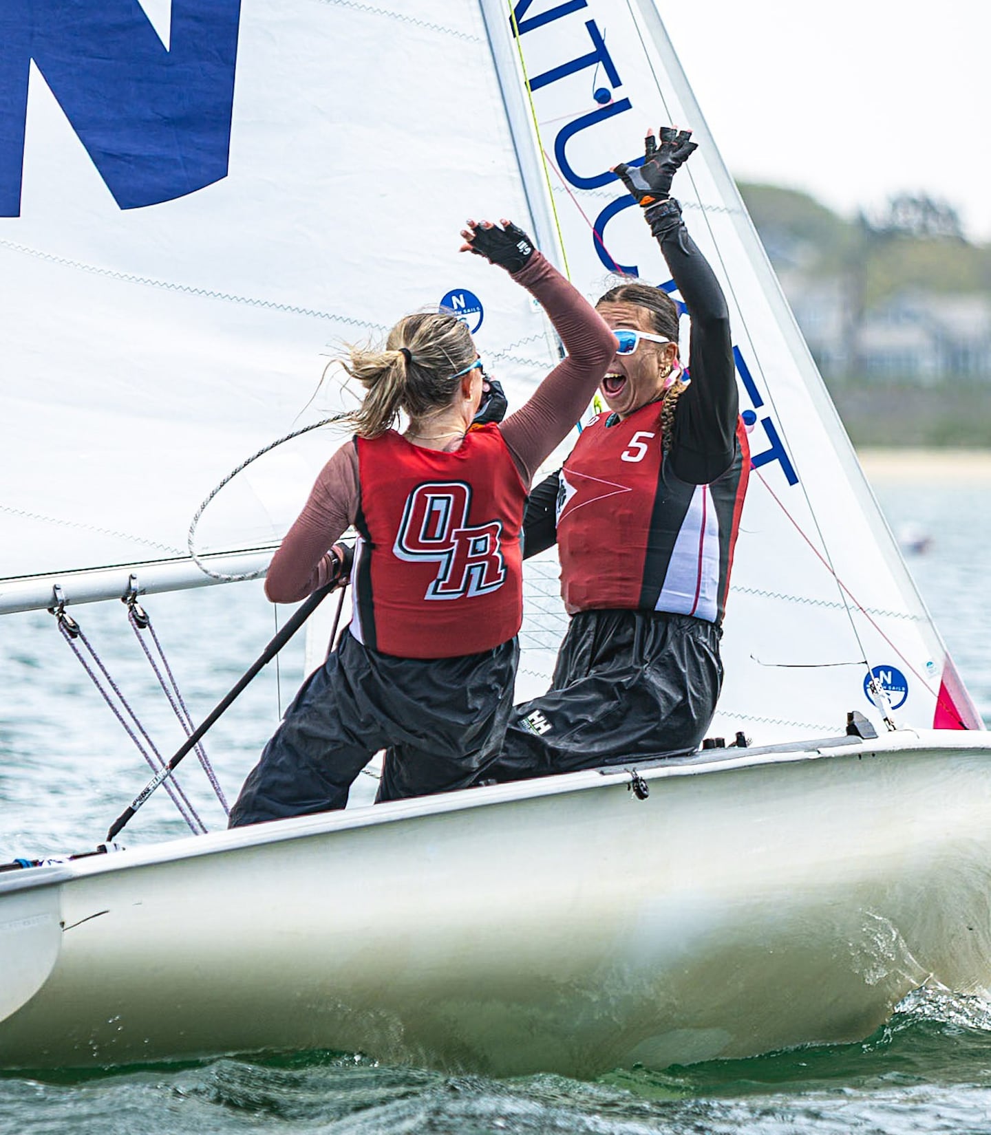 Old Rochester sophomores Claire Vergoni (left) and Rebecca Schaefer celebrate after bulleting in the final race of the Cape & Islands Girls' Invitational on May 27, 2026.