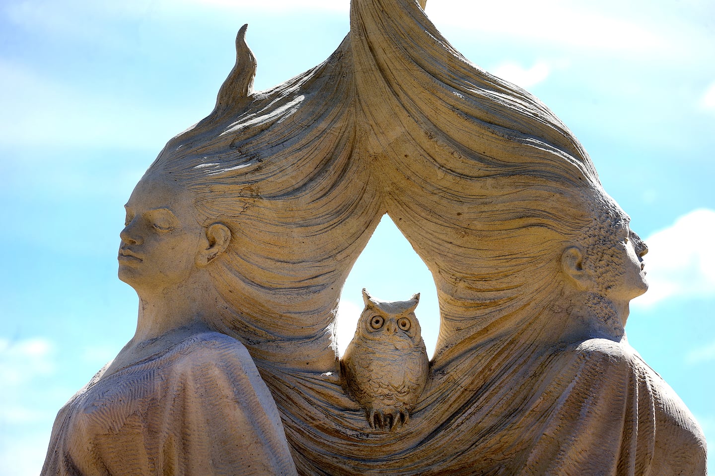 The finished heads framing an owl sculpture alled "Spiritual Affinity," created by Dmitry Klimenko from Saint Petersburg, Russia.