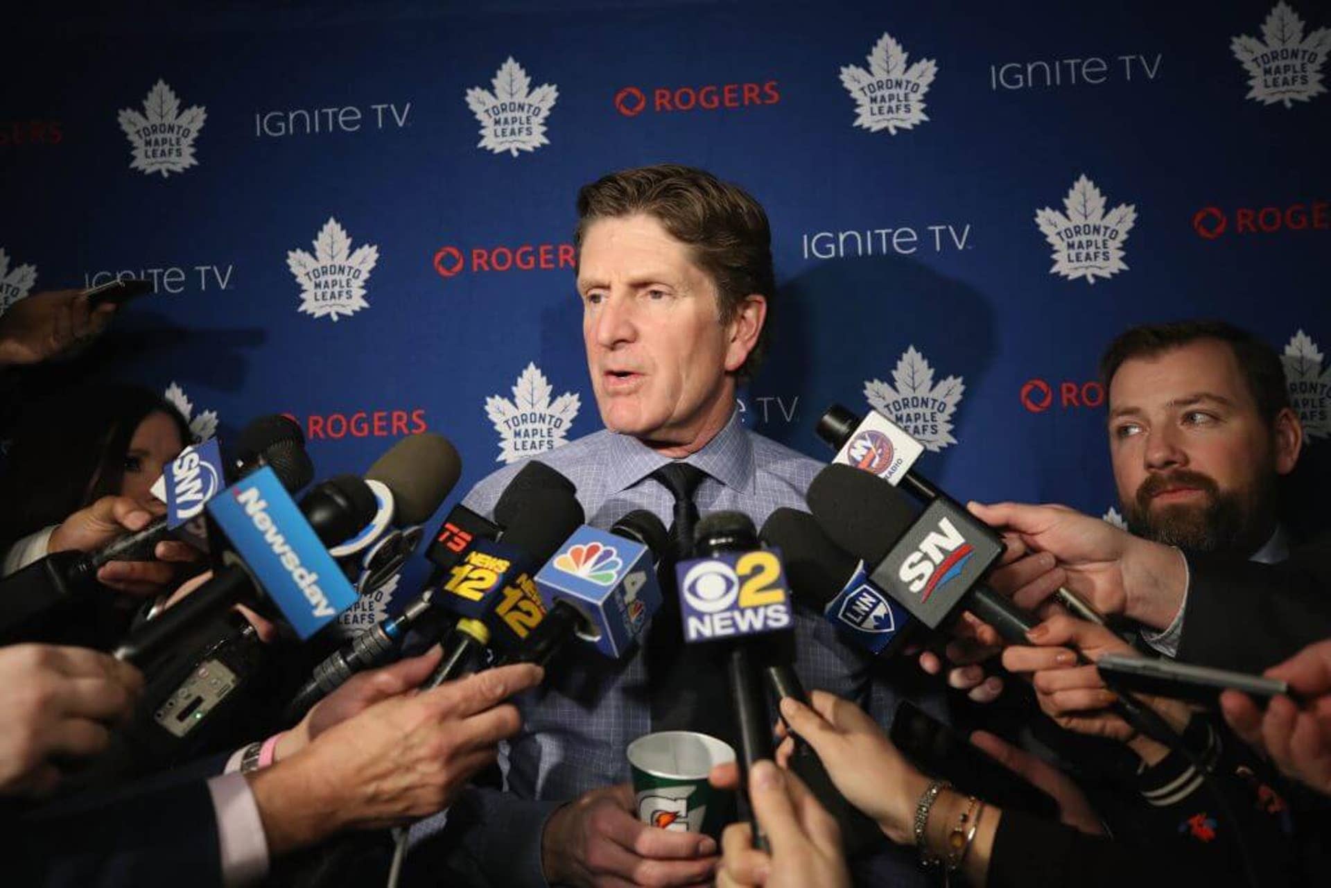 Mike Babcock is pictured addressing the media as coach of the Maple Leafs in 2019.