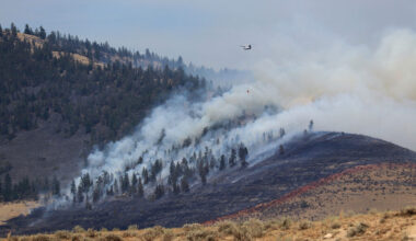 A helicopter crew battles a wildfire near Kalispell, Mont., in August 2022. Credit: Don and Melinda Crawford/Universal Images Group via Getty Images